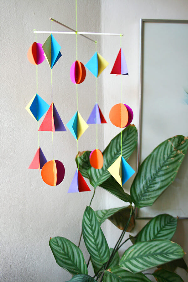 If you are looking for colorful geometric nursery mobile here is a super easy DIY.